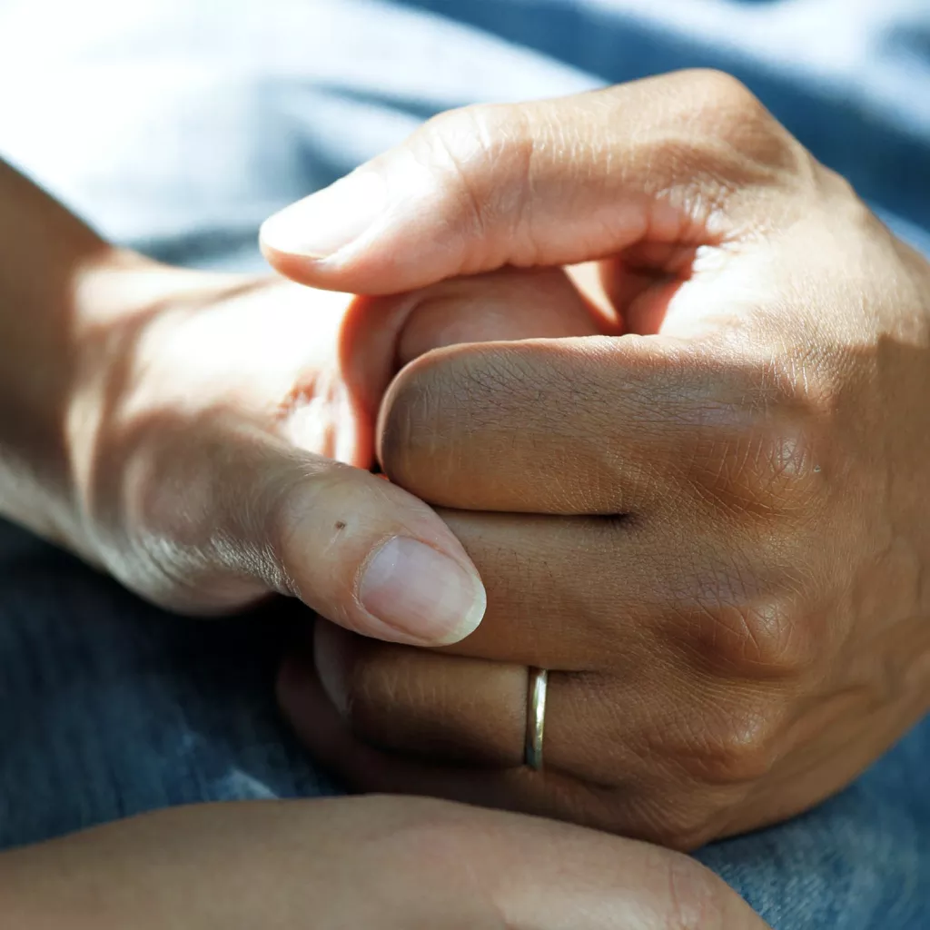 Someone's hand is being held in support.