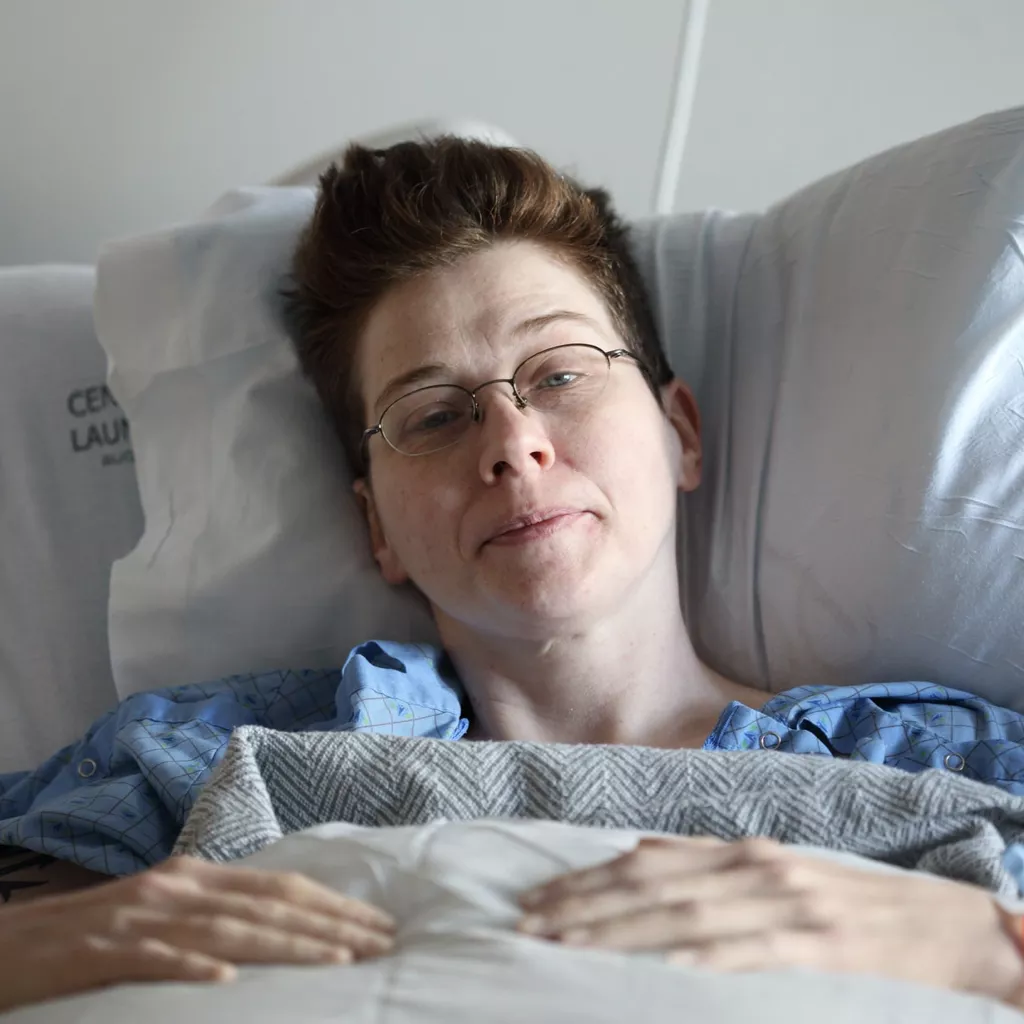 A lady in a hospital bed.