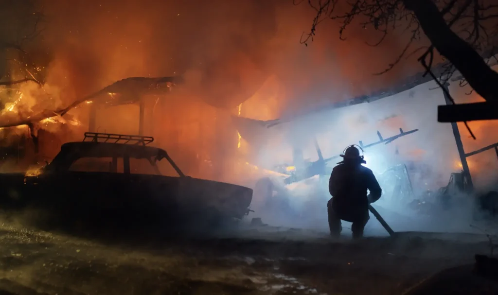 The fireman trying to extinguish a house fire