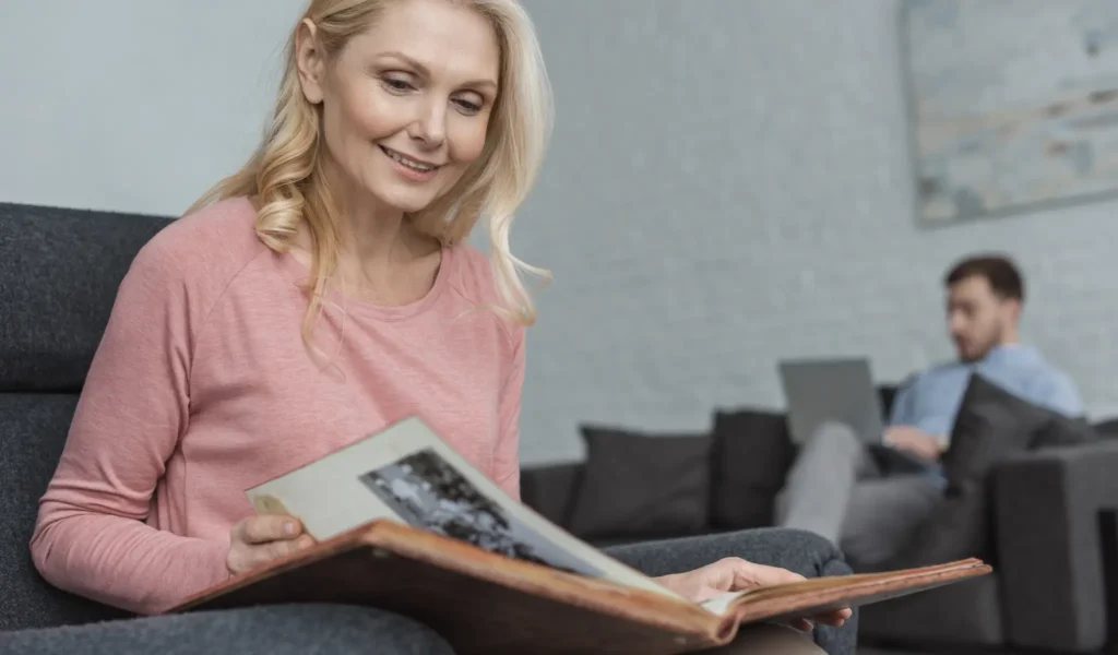 Printed books and digital family history beign consumed by two adults