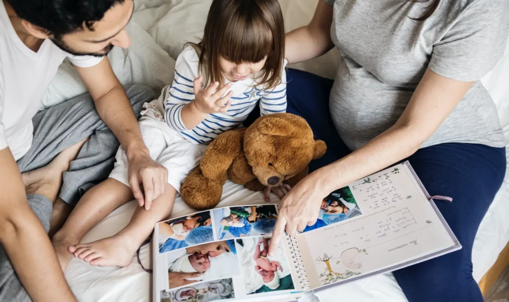 A family looking through a book about their family history