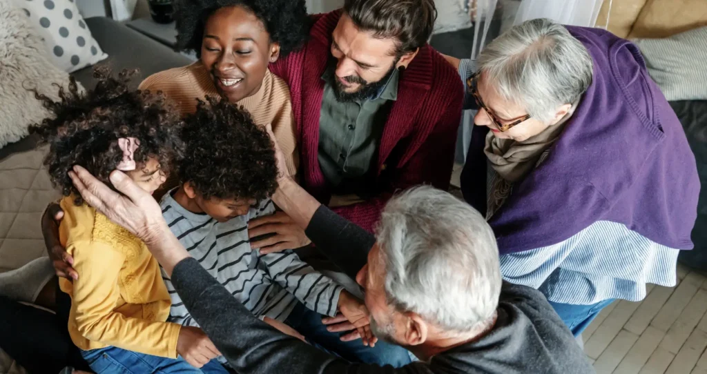 A multigenerational family, pouring their attention on two children