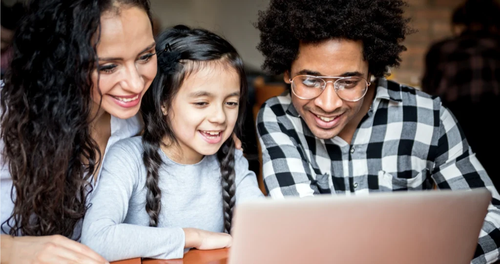 A family looking at their digital journaling apps on a computer