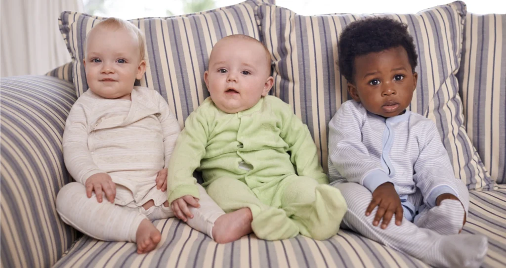 Three babies looking straight ahead