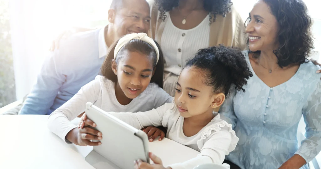 A family looking at digital family stories on a tablet