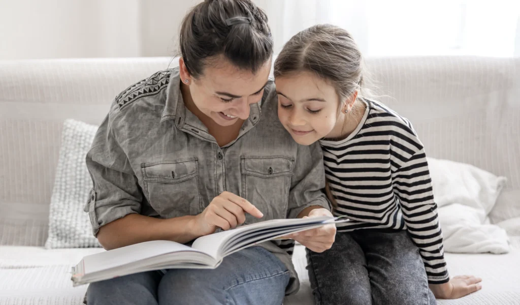 A family memory journal being looked about by a mother and her daughter