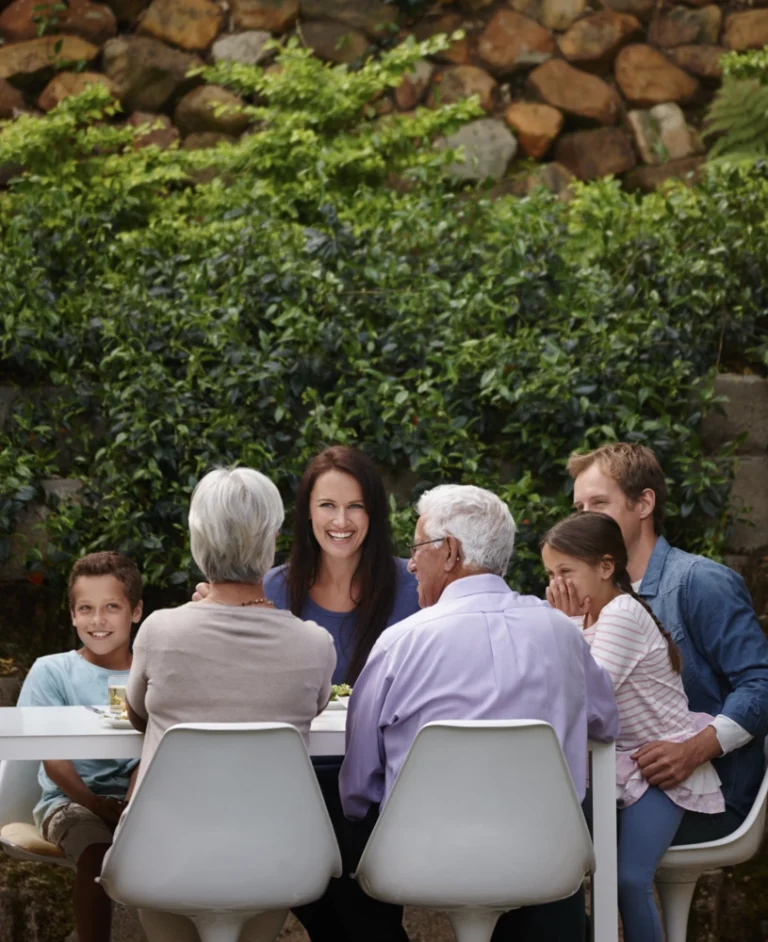 A multi generational family talking at the meal table