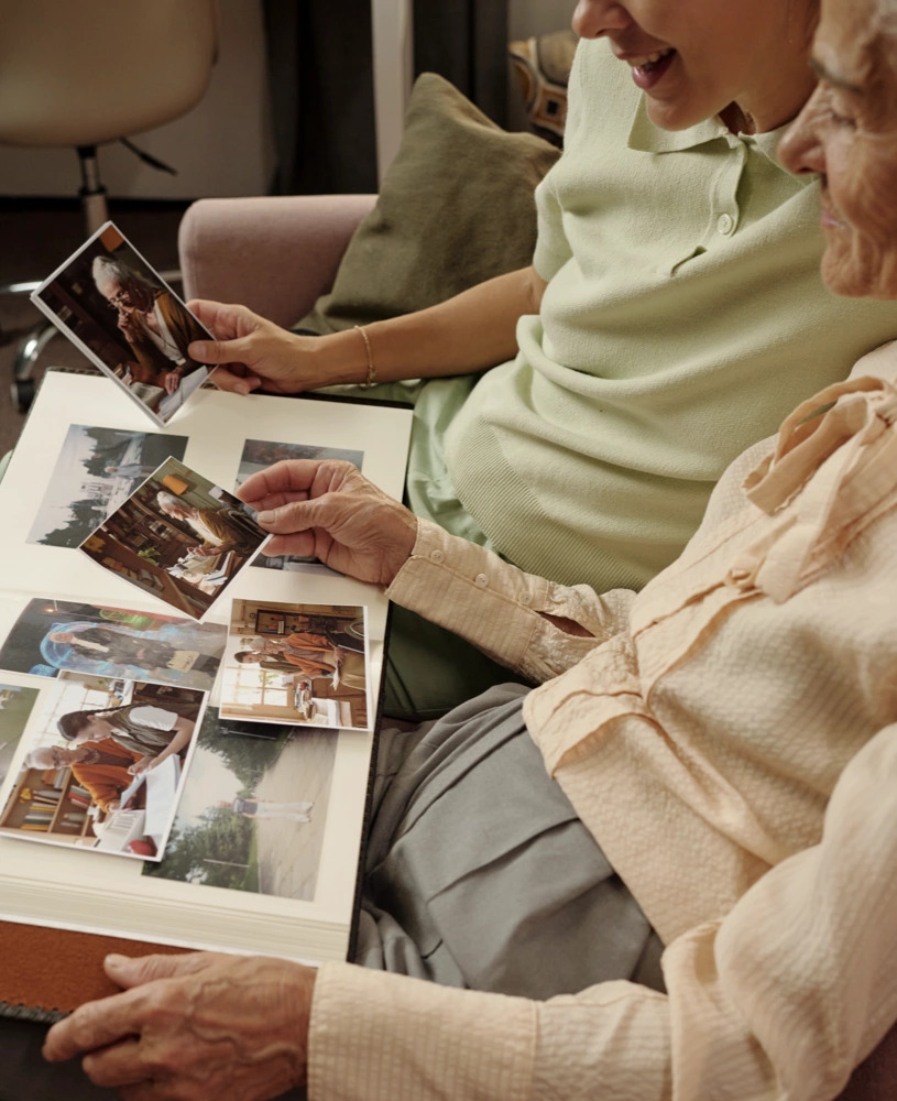 Two people looking at a family photo album