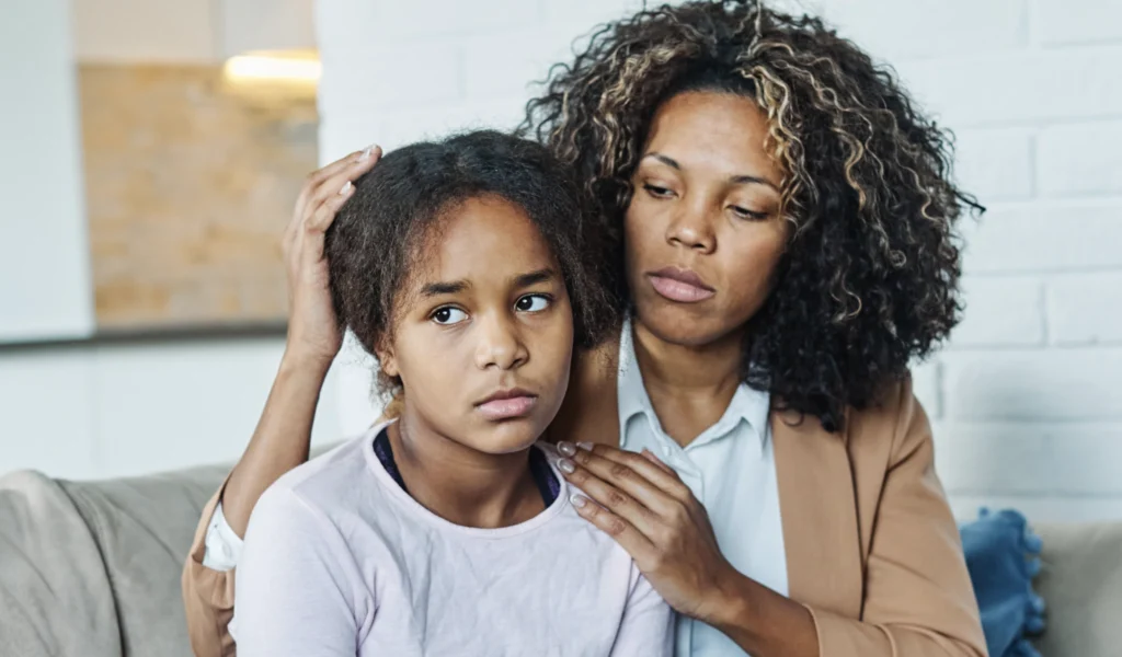 A mother trying to have a difficult conversation with her unresponsive daughter. 