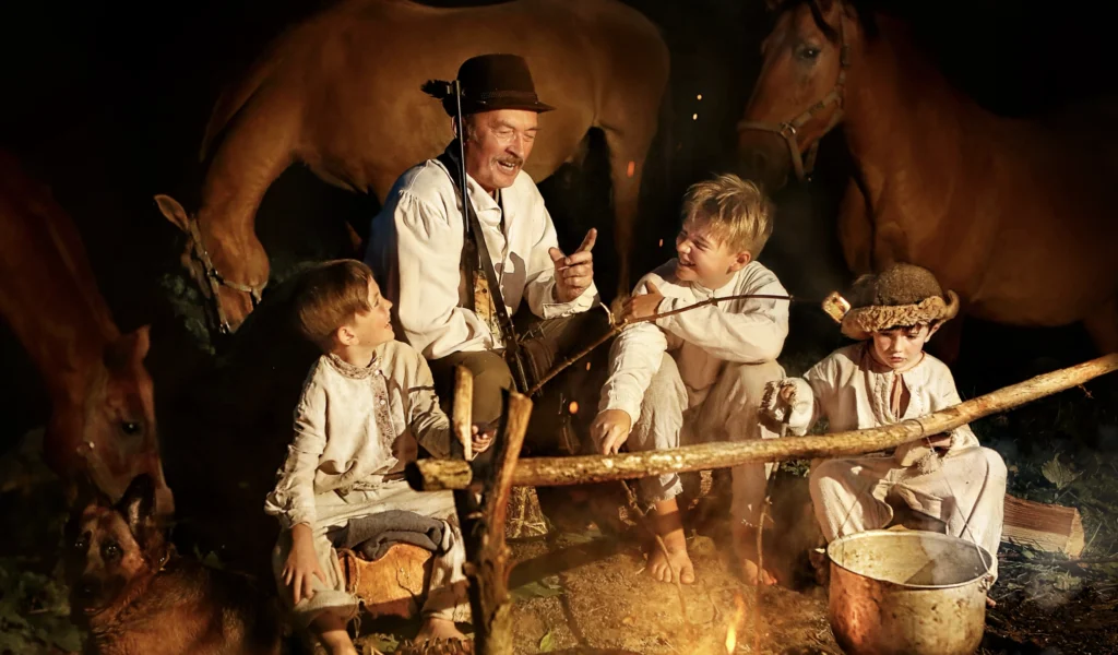An old-fashioned family scene around a fire, showing the importance of family storytelling