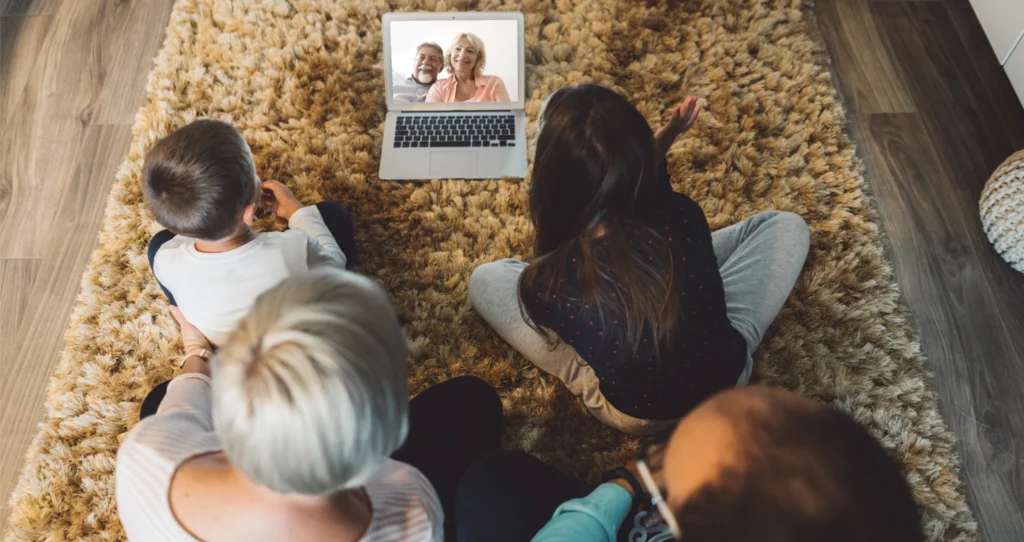 A family on a video call, connecting with grandparents living elsewhere.