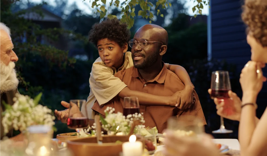 A multi-generational family having a discussion at dinner without phones. 