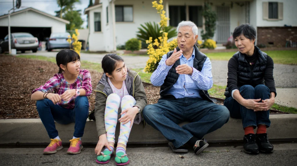 A grandfather telling a story to his two grandchildren. 