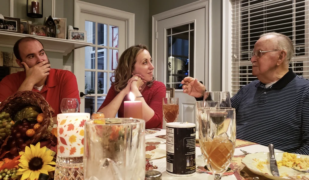 An elderly father sharing a story with his family