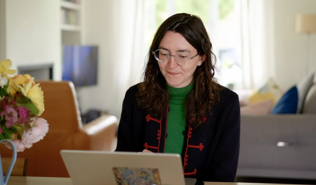 A lady on her laptop using the story downloads feature in the Simirity app