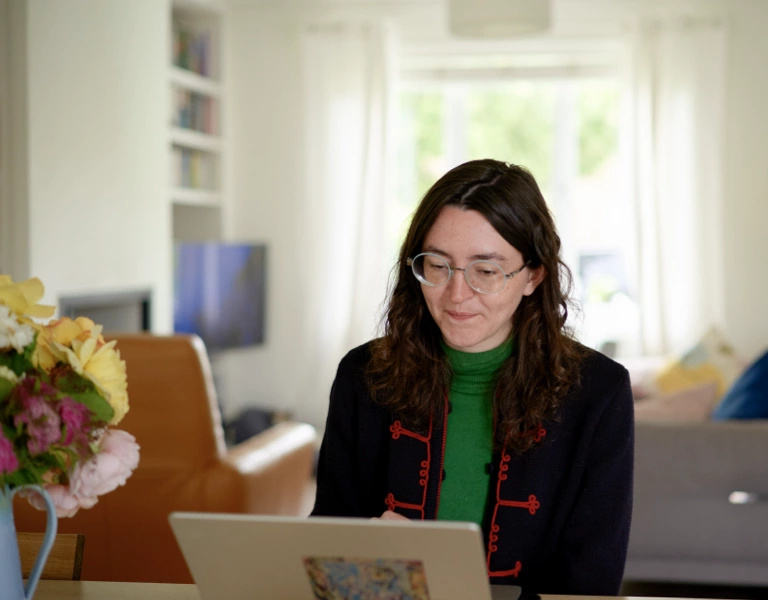 A lady in her home using her computer