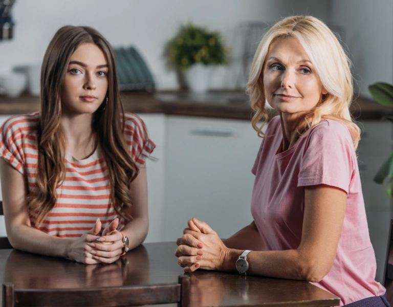 A mother having a difficult conversation with her teenage daughter