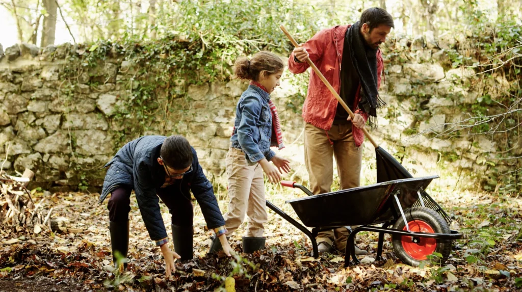 A father being a good role model to his children in the garden 