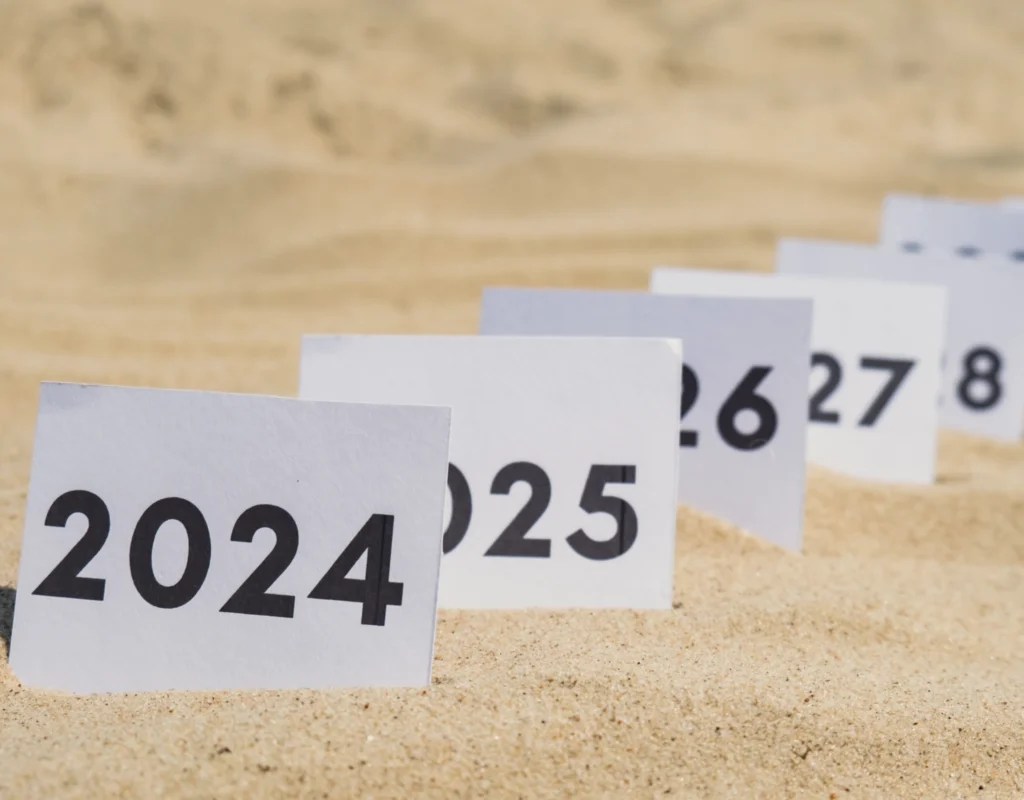 Cards in the sand with the years marked out