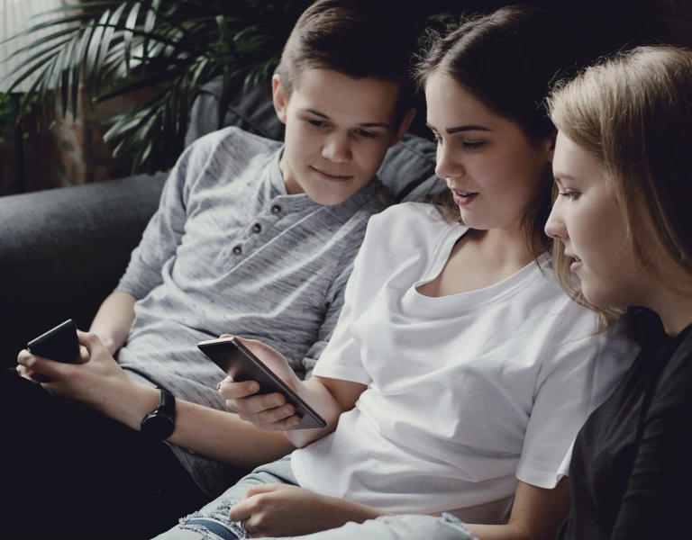 Children fully engaged in their mobile phones