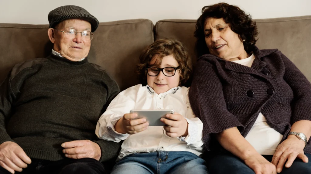 Grandparents feeling left out as they watched their grandchild on a device